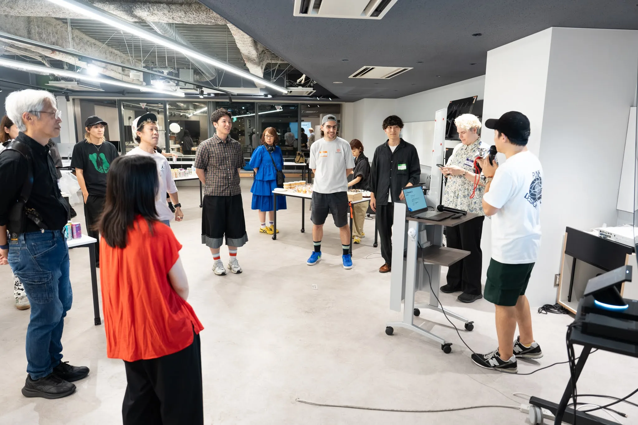 Speakers and guests standing in a circle in the meetup space during the introduction
