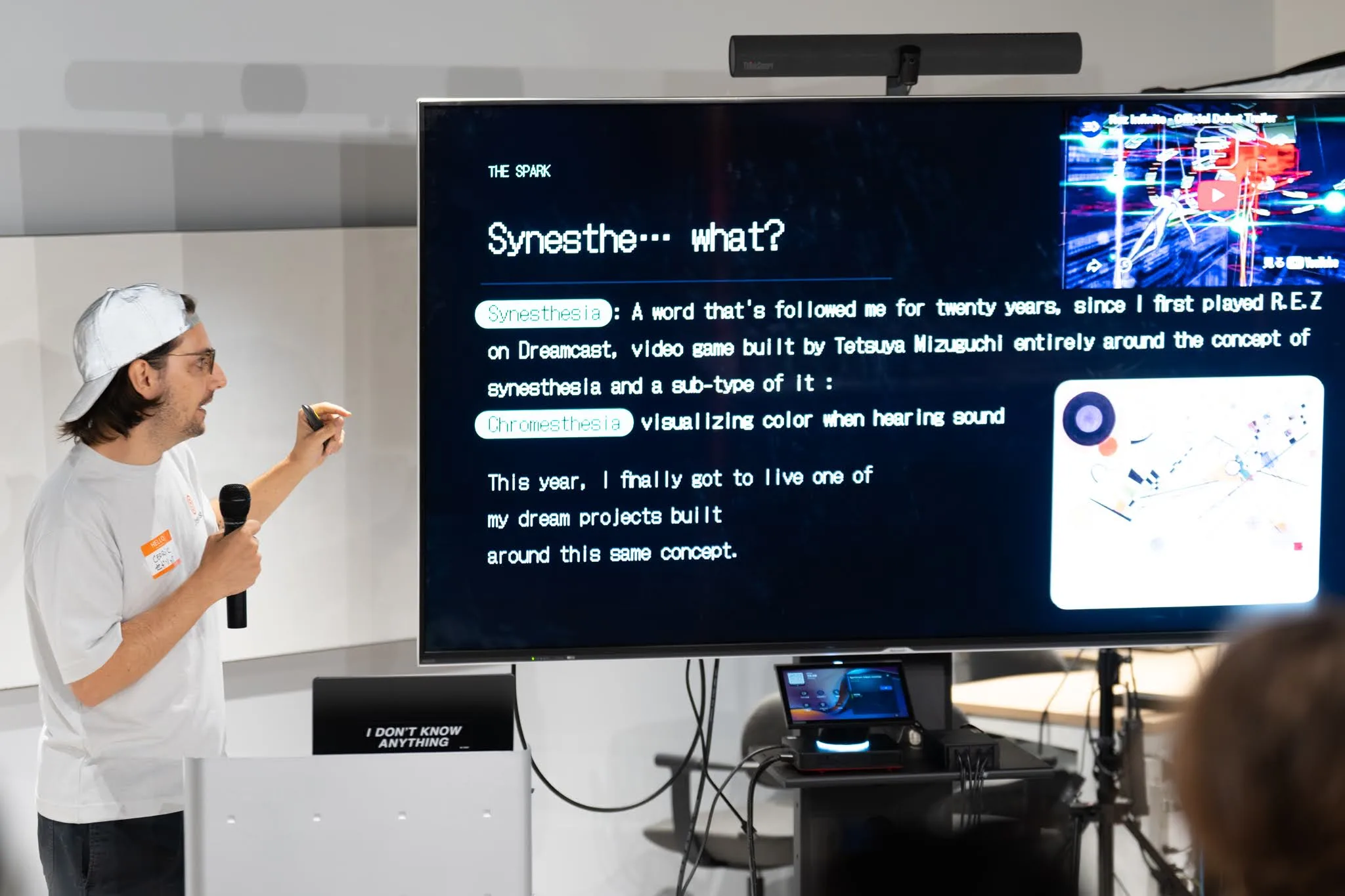 Cédric pointing at the Synesthe... what? slide, with a Rez trailer and a Kandinsky painting on screen